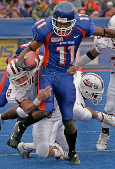
New Mexico State's Matt Griebel hauls down Boise State's Drisan James. 
 (Associated Press / The Spokesman-Review)