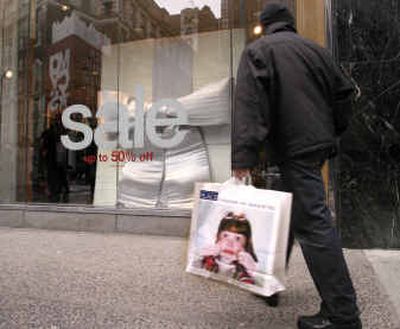 
A sale is advertised in midtown Manhattan on Sunday. After struggling with disappointing sales throughout the holiday season, retailers were heartened with a strong sales surge last week, and a busy shopping day after Christmas, creating hope that the nation's stores would meet their modest sales goals. 
 (Associated Press / The Spokesman-Review)