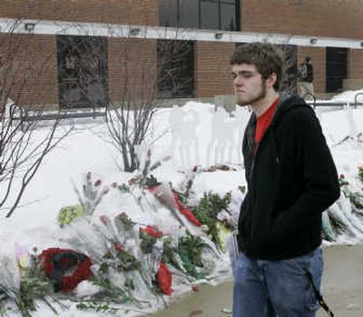 
A Northern Illinois University student passes a memorial outside Cole Hall on Monday, the first day of classes since the Feb. 14 shootings that killed five students  on the campus in Dekalb, Ill. Associated Press
 (Associated Press / The Spokesman-Review)