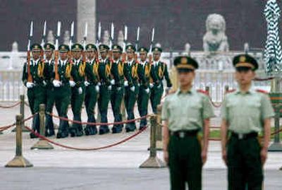
Chinese police march onto Beijing's Tiananmen Square for the daily flag-raising ceremony at dawn today. Chinese police march onto Beijing's Tiananmen Square for the daily flag-raising ceremony at dawn today. 
 (Associated PressAssociated Press / The Spokesman-Review)
