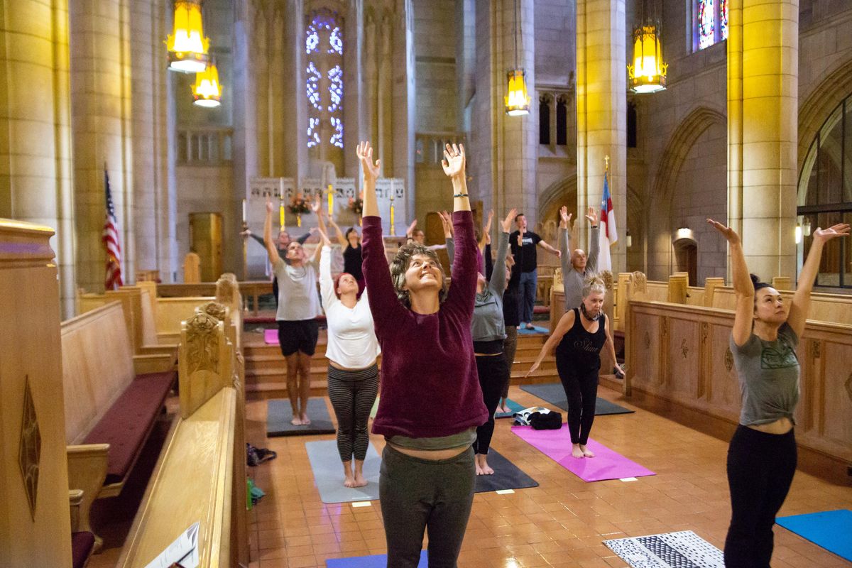 People attend a Yoga in the Cathedral session at St. John’s Cathedral on the South Hill on Sept. 22. The nonspiritual-based, once-a-month class is taught by Lisa Silvestri, a communications professor at Gonzaga University. (Libby Kamrowski / The Spokesman-Review)