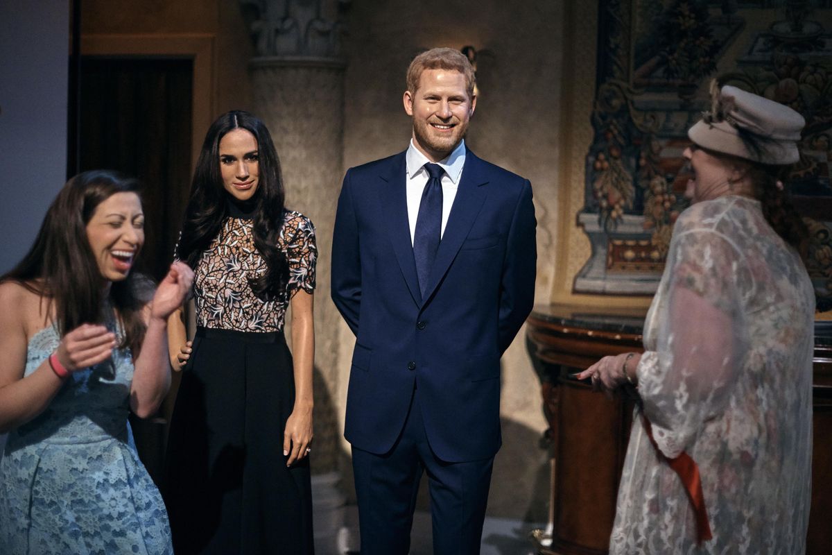 People take pictures of wax sculptures of Meghan Markle, second left, and Prince Harry, second right, during a viewing party of the royal wedding of Meghan Markle and Prince Harry of Wales, at the Madame Tussaud’s wax museum on Saturday, May 19, 2018, in New York. From pubgoers in pajamas to merrymakers in finery at a posh hotel, Americans cheered and teared up Saturday as they watched Meghan Markle marry Prince Harry in a royal wedding with trans-Atlantic resonance (Andres Kudacki / Associated Press)