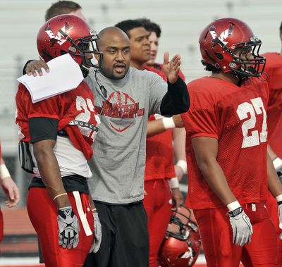 EWU running backs coach Kiel McDonald instructs Quincy Forte left, and Jordan Talley. (Dan Pelle)