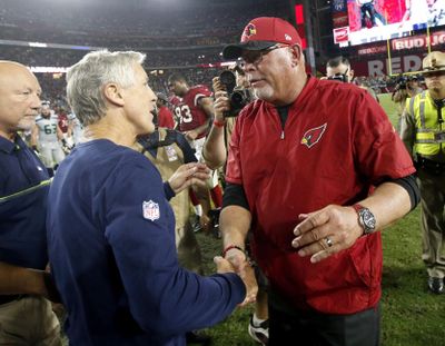 Seattle  coach Pete Carroll, left, greets Arizona coach Bruce Arians after their NFL teams played to a 6-6 tie on Sunday, Oct. 23, 2016, in Glendale, Ariz. (Ross D. Franklin / Associated Press)