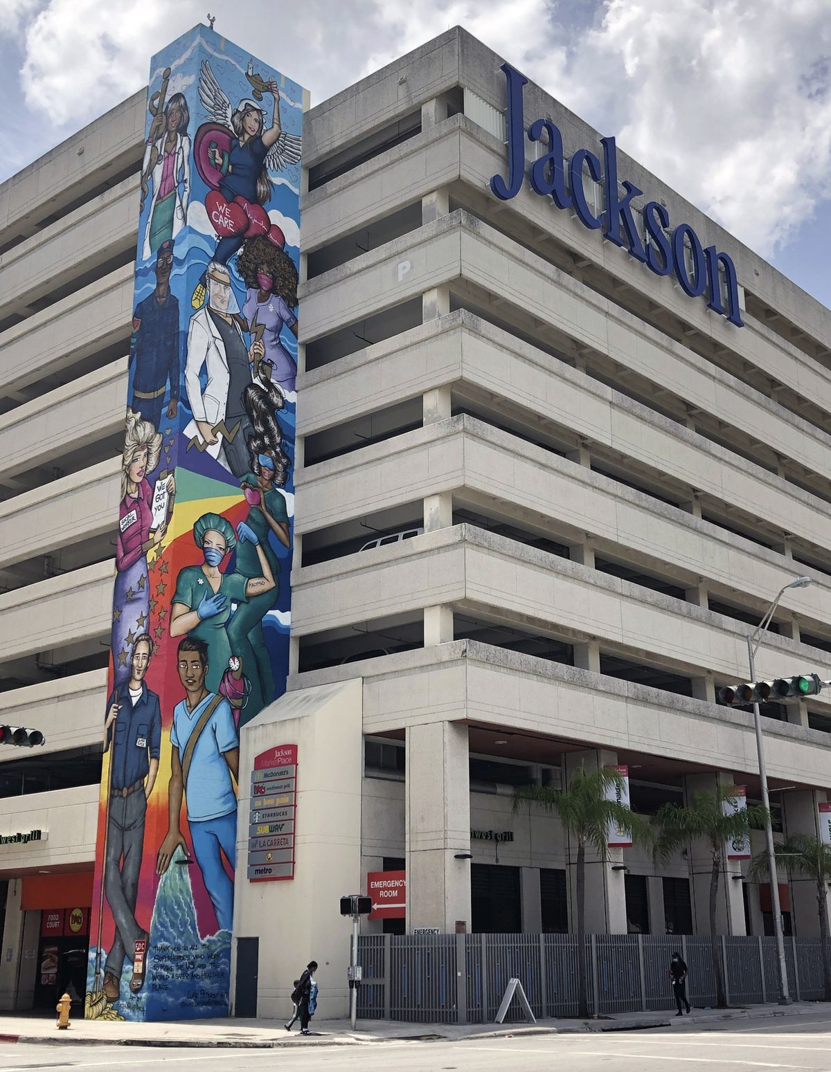 An mural paying tribute to front line healthcare workers is shown at Jackson Memorial Hospital, Thursday, July 9, 2020, in Miami. Florida reported on Thursday the biggest 24-hour jump in hospitalizations, with more than 400 patients being admitted. (Wilfredo Lee)