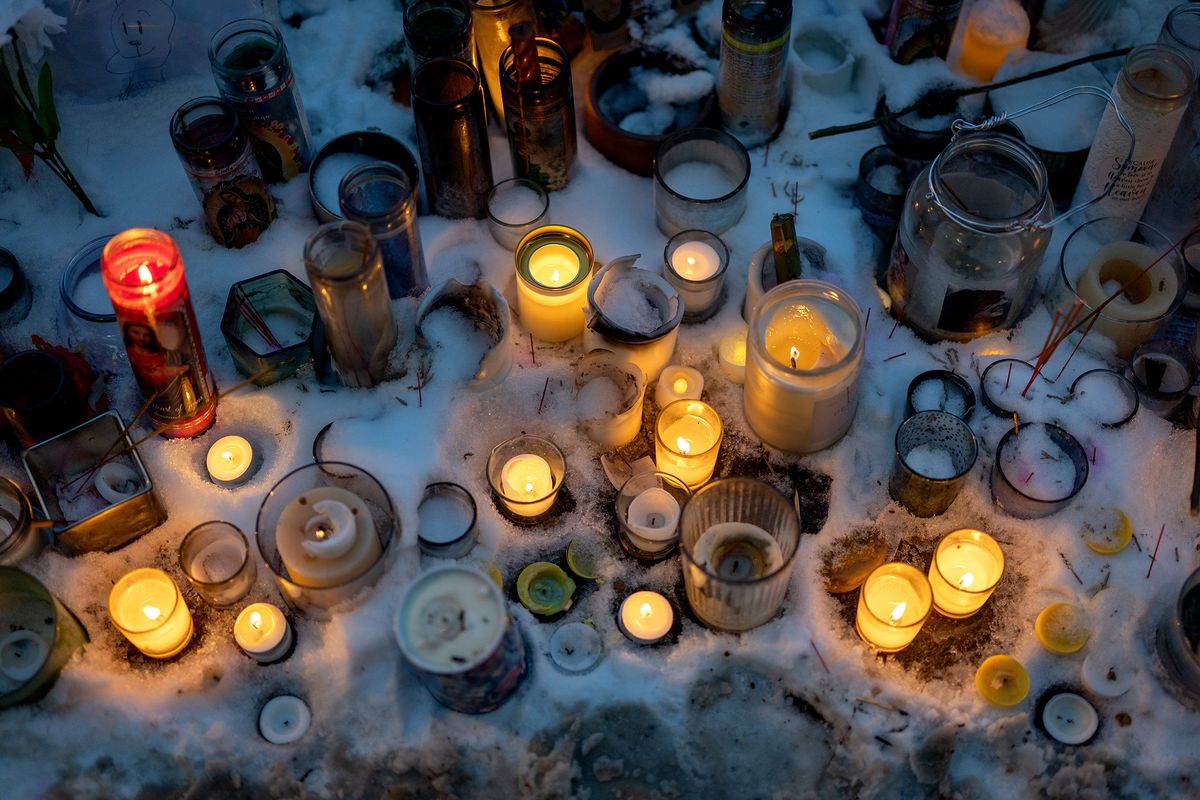 Candles burn near a memorial for Alex Pretti on Feb. 1 in Minneapolis.  (Los Angeles Times)