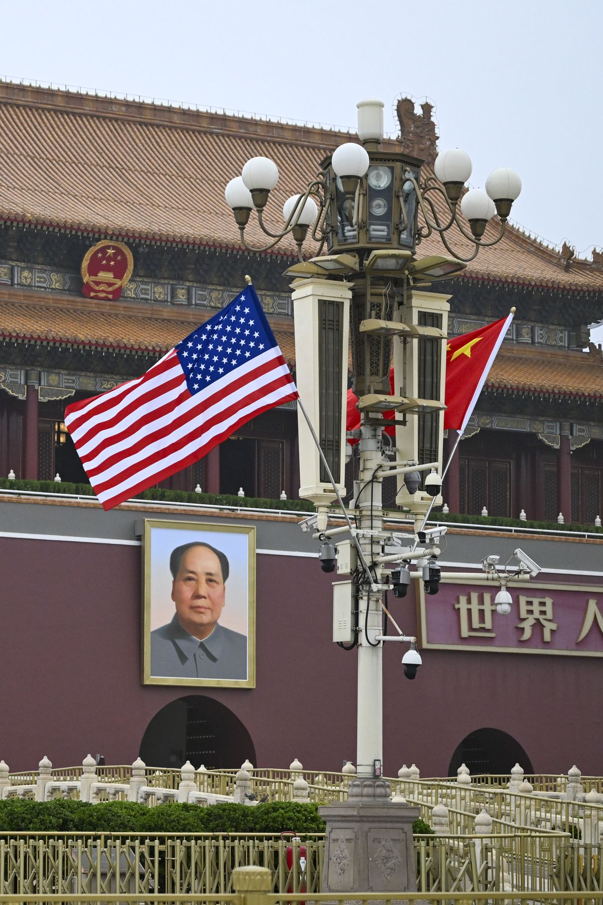 FILE -- American and Chinese flags fly over Tiananmen Square during President Donald Trump
