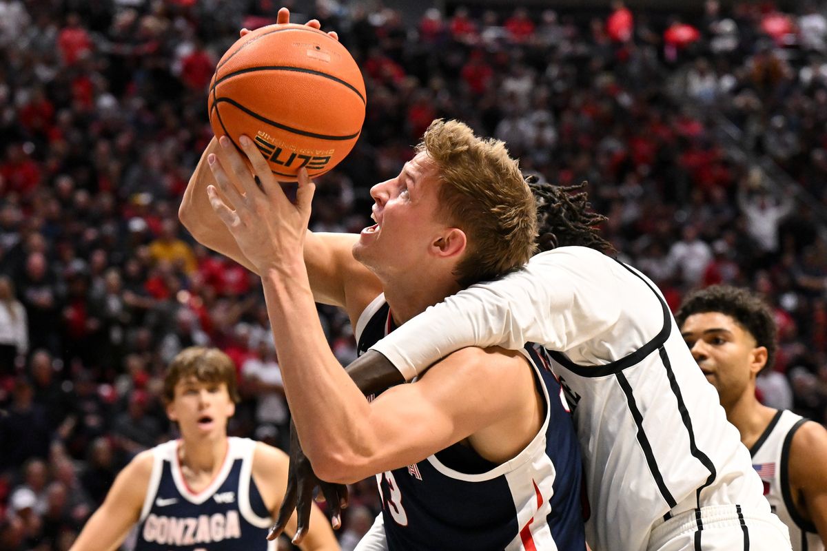 Gonzaga Bulldogs forward Ben Gregg (33) draws a foul from San Diego State Aztecs forward Magoon Gwath (0) during the second half of a college basketball game on Monday, Nov. 18, 2024, at Viejas Arena in San Diego, Calif. Gwath fouled out of the game on the play. Gonzaga won the game 80-67. 