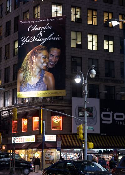 This undated photo provided by Jen Gallardo shows a billboard on the corner of 52nd St. and Broadway in New York featuring a photo of Charles Phillips and YaVaughnie Wilkins. Phillips, a co-president of software maker Oracle, acknowledges he had an affair with a woman he was shown snuggling with on billboards in New York, Atlanta and San Francisco. (Jen Gallardo / Jen Gallardo)