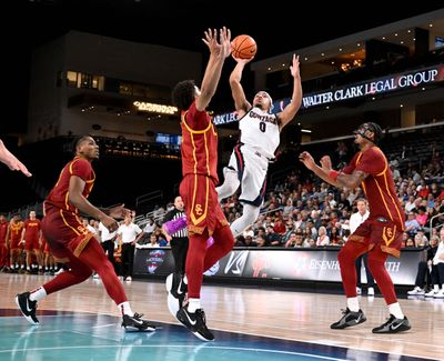 Gonzaga guard Ryan Nembhard (0) fades back as he shoots the ball over USC forward Matt Knowling (3) during the second half of a college exhibition basketball game, Sat. Oct. 26, 2024, at the Acrisure Arena in Palm Desert.  (Colin Mulvany / The Spokesman-Review)