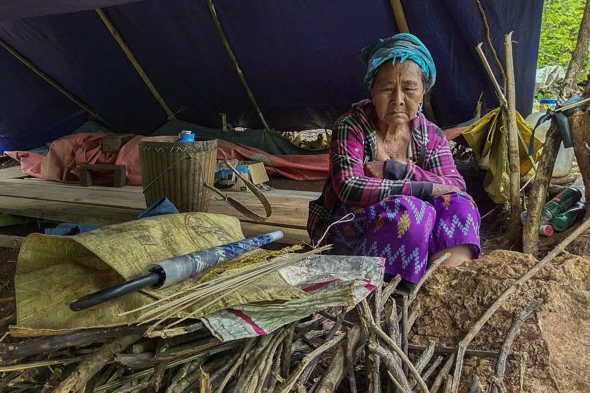 An internally displaced woman sits inside her makeshift tent at Pu Phar Village, Demawso Township, Kayah State on Thursday June 17, 2021. A report on the situation in conflict-affected areas of Myanmar issued this week by the U.N.