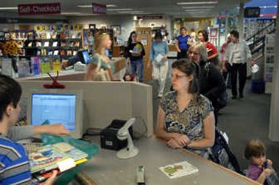 
Melissa Osborn  checks out books for her 3-year-old daughter Suzanna, right, at the Valley Library in Spokane Valleylast Thursday. Circulation as well as Internet and software-station use has increased at the library since last year, and patrons have been taking advantage of the new materials and services available. 
 (Holly Pickett / The Spokesman-Review)