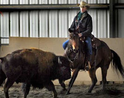
Wylie Gustafson exercises his horse at his Dusty, Wash., training facility on Thursday. The yodeling cowboy/author performs more than 50 shows per year with his band, Wylie and The Wild West. 
 (Joe Barrentine / The Spokesman-Review)