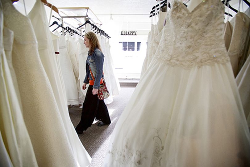 Danielle Owens walks through a display of wedding dress Friday at Storybook Bridal in Coeur d'Alene as she begins her wedding planning consultation with Cameo Events. (Jerome Pollos/press)