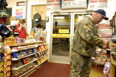 
Hunter Randy Boller gets coffee at 5:15 a.m. Saturday at the 3rd St. One Stop in St. Maries before heading out to hunt. At left is clerk Shelly Kruger, who opens the store at 3 a.m.
 (Jesse Tinsley / The Spokesman-Review)