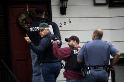 
Washington State Patrol Detective Major Bambino signals to other troopers before troopers entered a house at 7206 Mahr Court with a search warrant Wednesday. 
 (Holly Pickett / The Spokesman-Review)