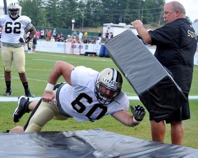 New Orleans center Max Unger (60) hits a mat during a drill at the Saints’ training camp in White Sulphur Springs, West Virginia. (Associated Press)