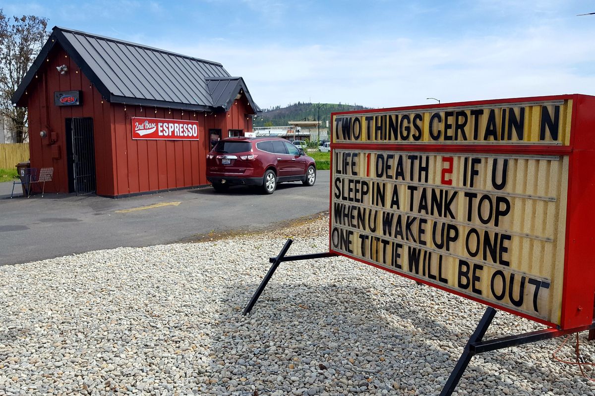 A sign at 2nd Base Espresso, a “bikini barista” stand in Spokane’s Hillyard neighborhood, as seen Monday, May 8, 2017. Neighbors often complain about the business’s advertising messages. (Chad Sokol / The Spokesman-Review)