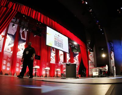 Construction crews work on the stage before the CBS News Republican presidential debate at the Peace Center, Saturday, Feb. 13, 2016, in Greenville, S.C. (John Bazemore / Associated Press)