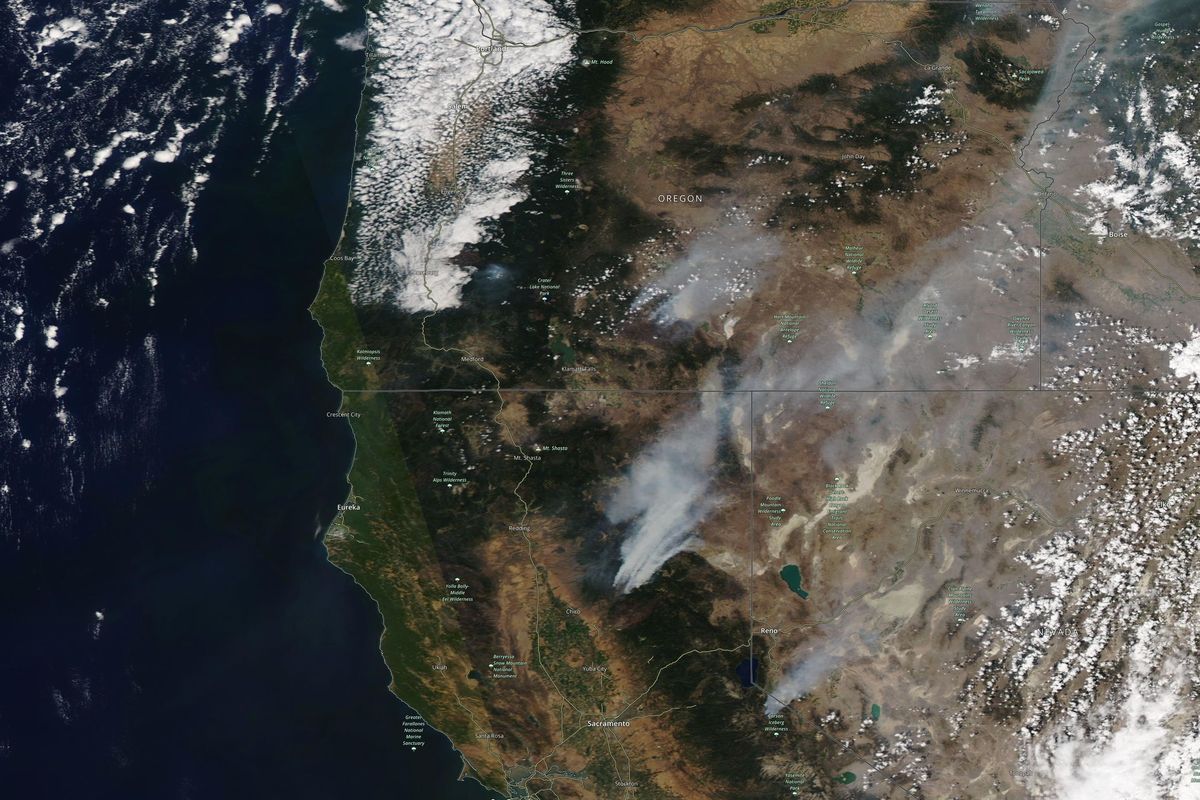 This satellite image provided by Satellite image ©2021 Maxar Technologies shows the wildfires in Northern California and Oregon on Wednesday, July 21, 2021. The Oregon fire, which was sparked by lightning, has ravaged the sparsely populated southern part of the state and had been expanding by up to 4 miles (6 kilometers) a day, pushed by strong winds and critically dry weather that turned trees and undergrowth into a tinderbox.  (HONS)