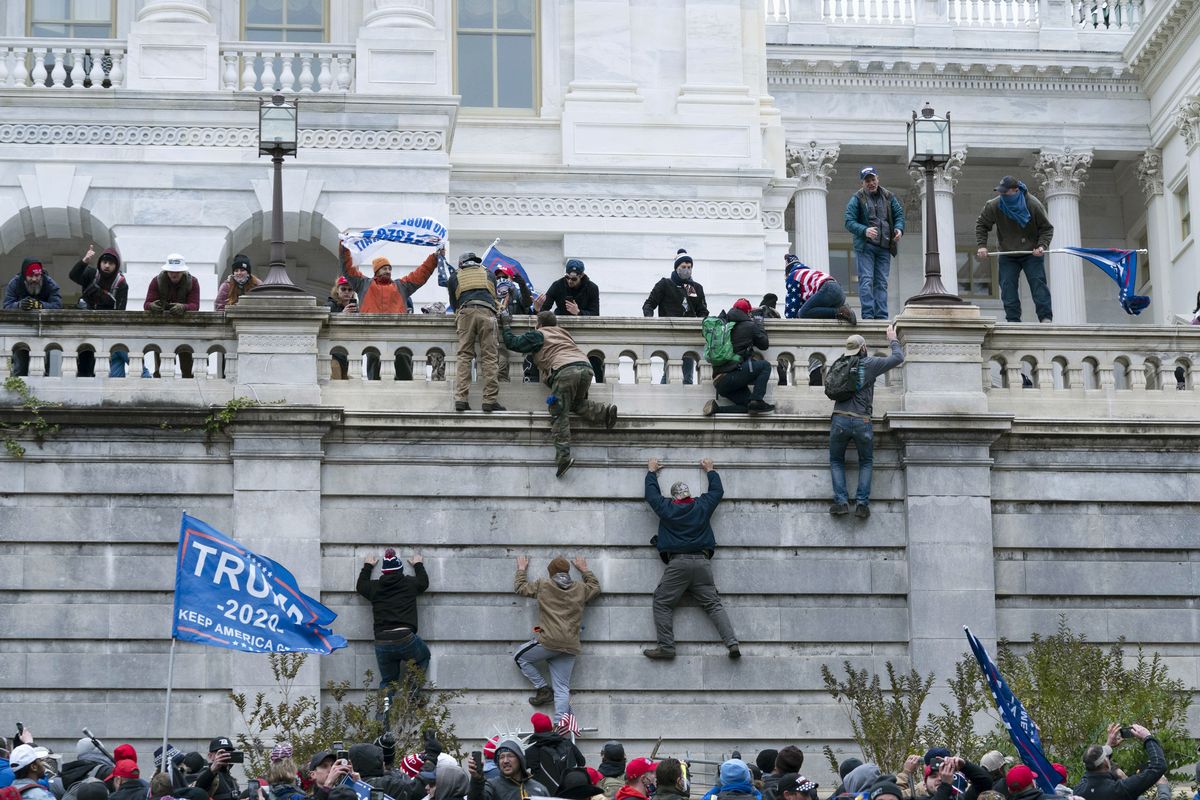 Supporters of President Donald Trump climb the west wall of the the U.S. Capitol on Wednesday, Jan. 6, 2021, in Washington.  (Jose Luis Magana)
