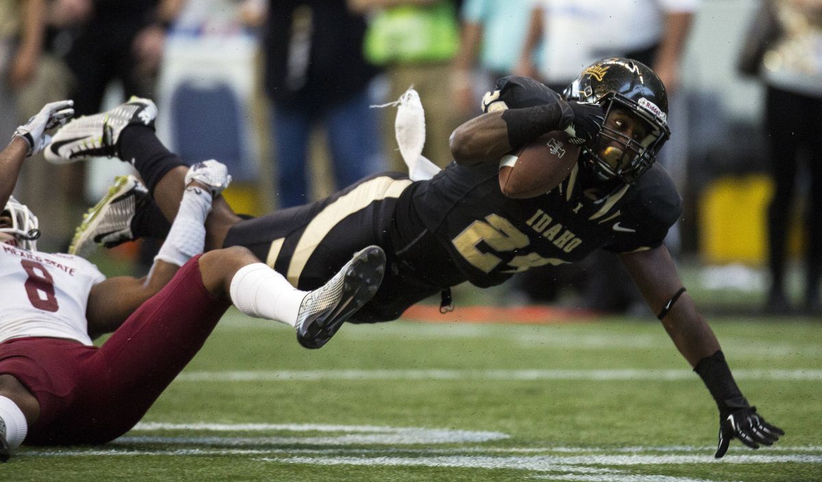 Idaho senior running back Jerrel Brown gets tripped up but stretches for a few more yards on his way to 151 yards rushing. (Associated Press)