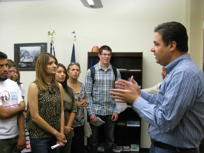 1st District Congressman Raul Labrador, right, talks with a  group of immigration reform activists at his Meridian office on Monday, including Ruby Mendez, at left. (Betsy Russell)