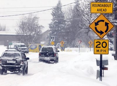 The recent onslaught of snowfall has not made life any easier at Spokane Valley’s first roundabout. Traffic moves more slowly as a result of the weather. The project has been met with mixed reviews, including residents of the large apartment complexes on Wilbur Road. The circular intersection was built to ease congestion at Mansfield Avenue, Montgomery Drive and Wilbur Road.  (J. BART RAYNIAK / The Spokesman-Review)