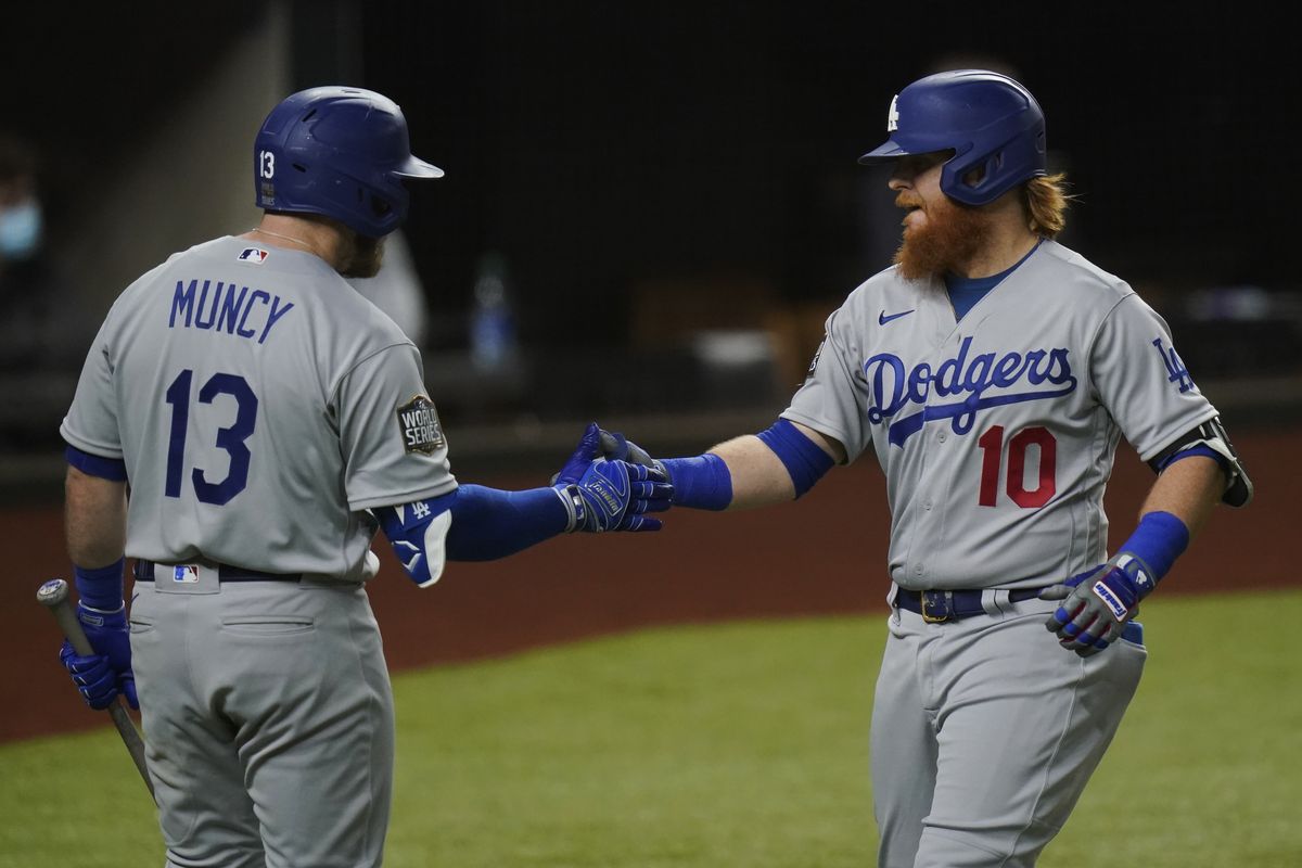The Los Angeles Dodgers’ Justin Turner, right, celebrates his home run with teammate Max Muncy during the first inning in Game 3 of the World Series against the Tampa Bay Rays on Friday in Arlington, Texas.  (Associated Press)