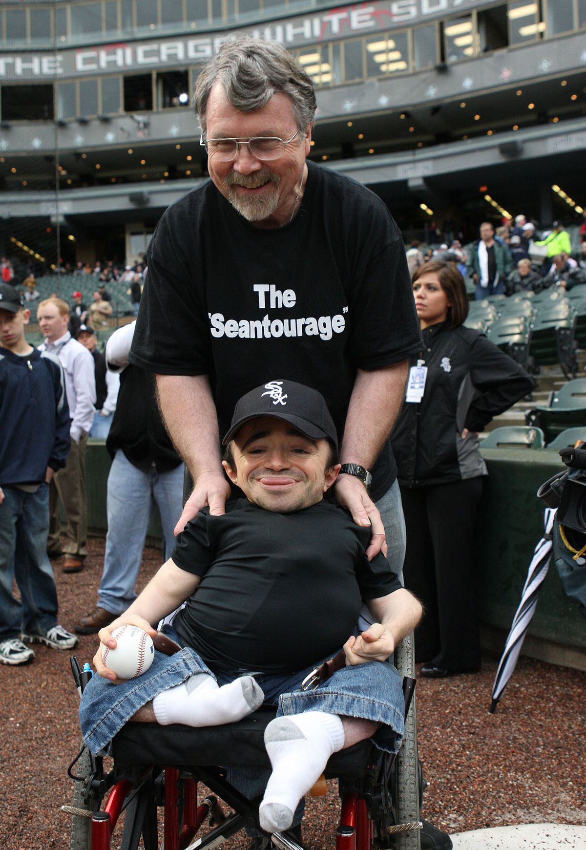 Sean Stephenson is pushed by his father, Gregg, onto the field at U.S. Cellular Field. (Nuccio Dinuzzo / The Spokesman-Review)