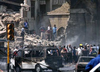 
Iraqis gather at the damaged Khillani mosque, a main Shiite religious site in central Baghdad, on Tuesday  after a truck bomb struck,  killing at least 60. Associated Press photos
 (Associated Press photos / The Spokesman-Review)