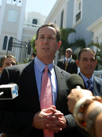Rick Santorum talks with reporters after meeting with Puerto Rico Gov. Luis Fortuno in San Juan, Puerto Rico, on Wednesday. (Associated Press)