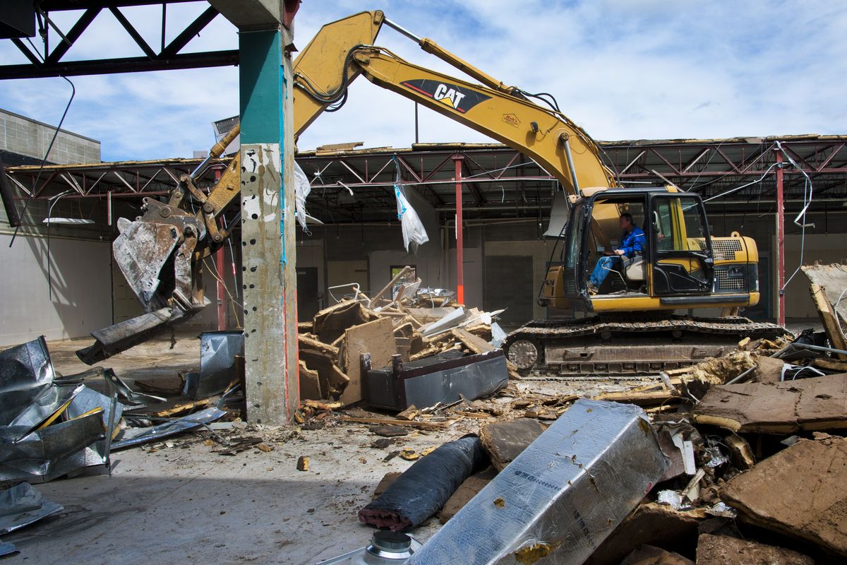 Crews from Rob’s Demolition tear apart the east end of the University City Mall on Friday in Spokane Valley. (Dan Pelle)