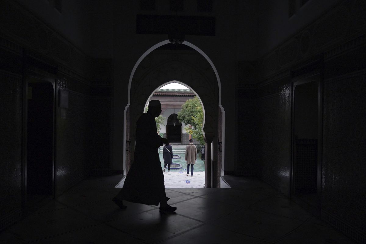 A man walks inside a mosque in Paris, France on Thursday.  (Thibault Camus)