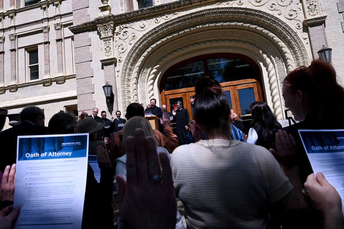 Breean L. Beggs, center, a Spokane Superior Court Judge leads local lawyers and judges in taking their professional oath during a Law Day demonstration on Thursday, May. 1, 2025, at in Spokane, Wash. Local lawyers and judges came together on the steps of the courthouse to retake their professional oath, emphasizing their obligation to protect and uphold the Constitution.  (Tyler Tjomsland/The Spokesman-Review)