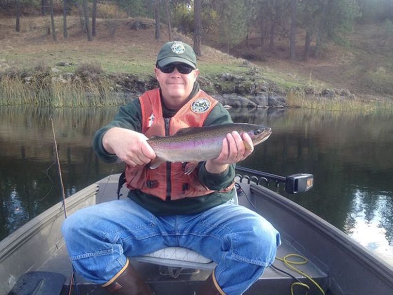 Randy Osborne, Washington Department of Fish and Wildlife fisheries biologist, holds a rainbow trout from Amber Lake in Spokane County. (Washington Fish and Wildlife Department)