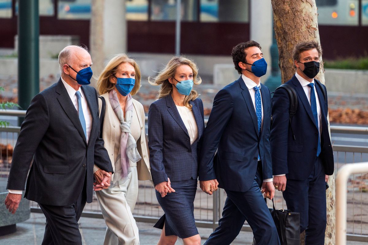 Elizabeth Holmes, center, walks into federal court in San Jose, Calif., Friday, Dec. 17, 2021. The lawyers for the opposing sides in the trial of former Theranos CEO are expected to wrap up their closing arguments Friday, paving the way for a jury to begin their deliberations over criminal charges accusing her of turning her blood-testing startup into a massive scam.  (Nic Coury)