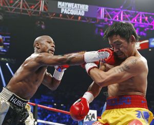 Floyd Mayweather Jr. connects with a right to the head of Manny Pacquiao. (Associated Press)