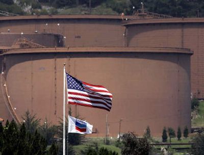 
Flags fly near an entrance to the Chevron's Richmond Refinery with tanks in the background in Richmond, Calif., on Friday. Chevron Corp.'s first-quarter profit soared 49 percent to $4 billion. 
 (Associated Press / The Spokesman-Review)