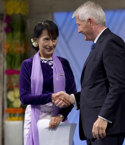 Peace prize laureate Aung San Suu Kyi is congratulated by Thorbjoern Jagland, chairman of the Norwegian Nobel Committee, in Oslo, Norway, on Saturday. (Associated Press)