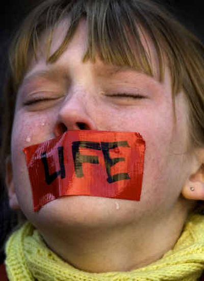
Rachel Anderson, age 11, cries as she prays during the anti-abortion protest at the federal courthouse Monday in downtown Spokane. 
 (Colin Mulvany / The Spokesman-Review)