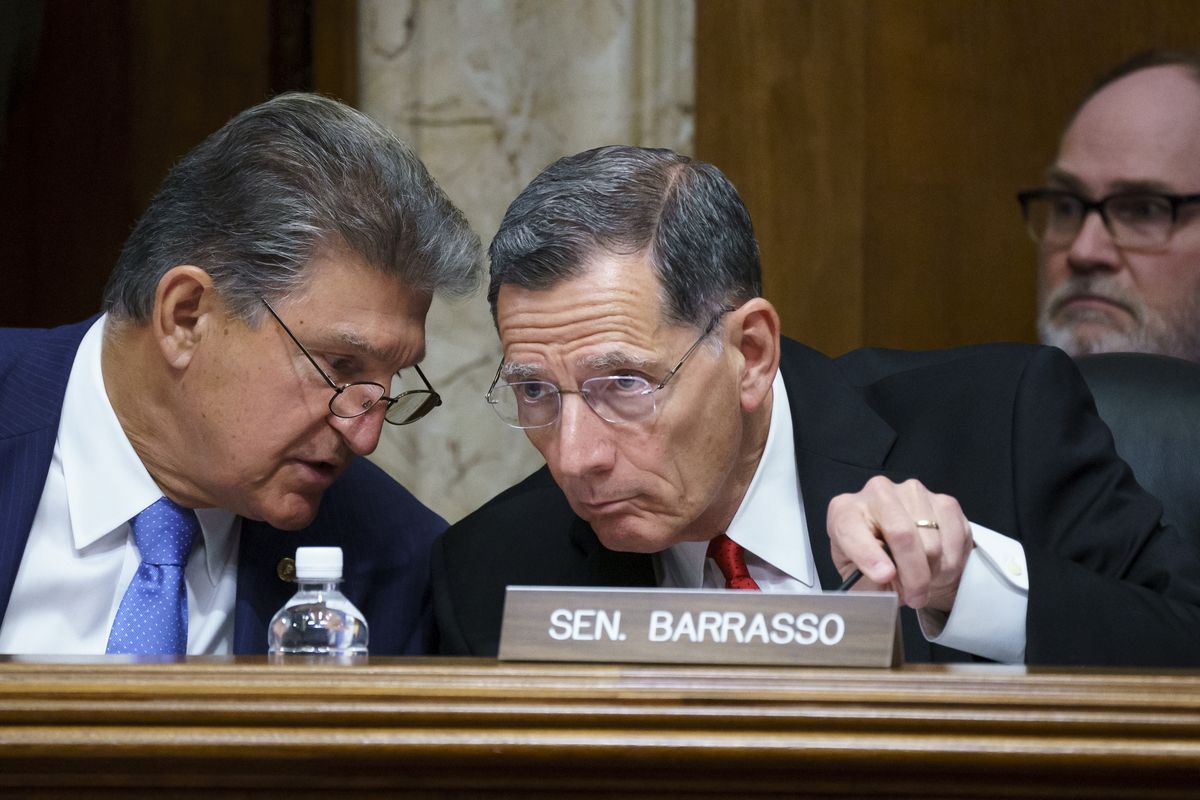 FILE - In this June 23, 2021, file photo, Sen. Joe Manchin, D-W.Va., chair of the Senate Energy and Natural Resources Committee holds a hearing with Ranking Member Sen. John Barrasso, R-Wyo., right, at the Capitol in Washington. A former federal law enforcement officer is alleging that President Joe Biden