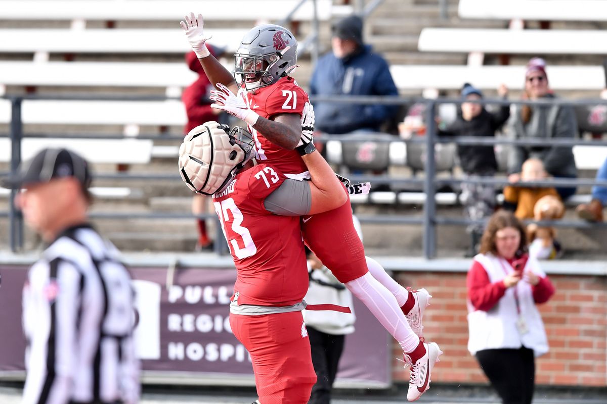 Cougars running back Wayshawn Parker soars Saturday after his touchdown during the Crimson and Gray Game.  (Tyler Tjomsland/The Spokesman-Review)