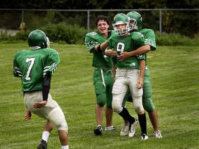 
East Vallley junior defensive back Jye Lanphere (9) is mobbed by his fellow Knights after an interception for a touchdown during a recent scrimmage. 
 (Brian Plonka / The Spokesman-Review)