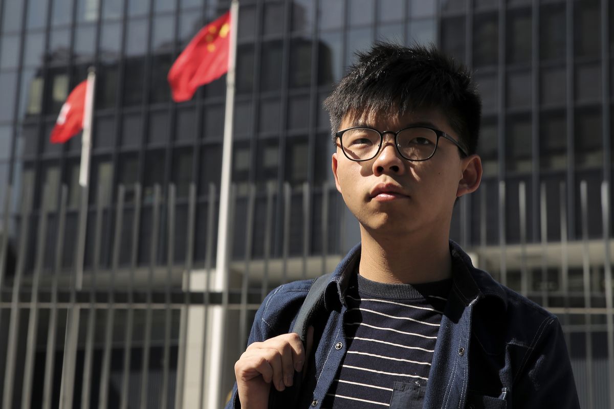 FILE - In this Nov. 28, 2019, file photo, pro-democracy activist Joshua Wong stands outside the Legislative Council building in Hong Kong. Wong, currently serving a 13 1/2 month prison sentence for organizing and participating in an unauthorized 2019 protest, has been arrested on a new charge under the national security law while an American rights lawyer who was detained in a sweeping crackdown was granted bail.  (Kin Cheung)