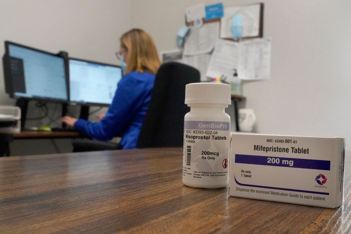 A nurse practitioner works in an office at a Planned Parenthood clinic where she confers via teleconference with patients seeking self-managed abortions as containers of the medication used to end an early pregnancy sit on a table nearby, Oct. 29 in Fairview Heights, Ill.  (Jeff Roberson)