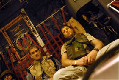 
Correspondent Jim Hagengruber, left, and Spokesman-Review photographer Brian Plonka ride a C-130 transport from Kuwait to Baghdad. 
 (Brian Plonka / The Spokesman-Review)