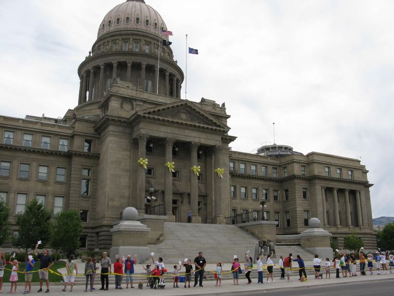 Hundreds of people stretch a yellow ribbon around Idaho's state Capitol on Friday to mark the 25th anniversary of the Americans with Disabilities Act (Betsy Z. Russell)