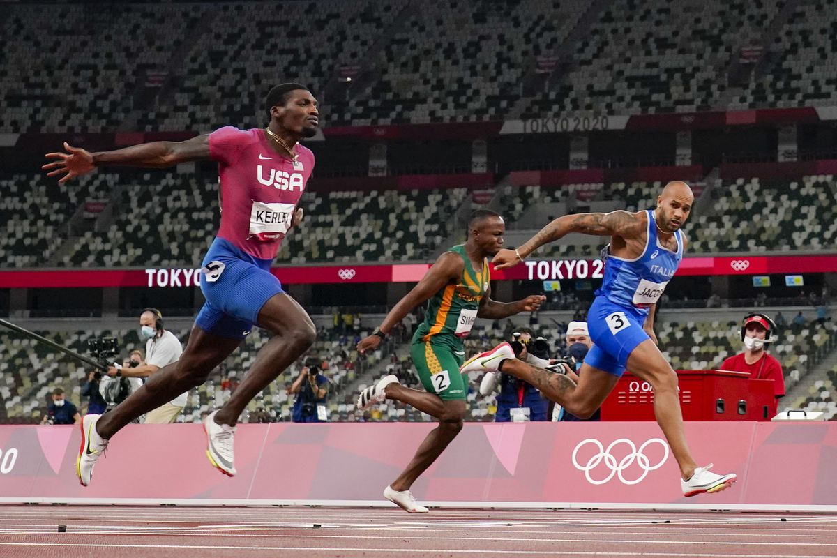 Lamont Jacobs, right, of Italy, wins the men