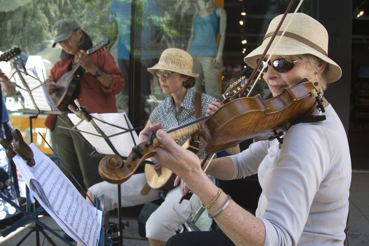 Fiddler Jan Giesa, right, plays Celtic tunes with the Kitchen String Band in front of a downtown Spokane store on Main Avenue in 2015 during Street Music Week, a busking festival to raise money for Second Harvest. (Jesse Tinsley / The Spokesman-Review)